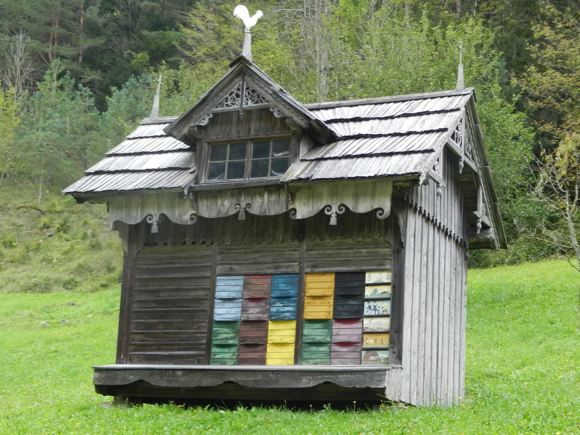 A traditional Slovenian bee house with painted hive fronts